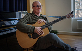 Lars Berglund sitter med gitarr